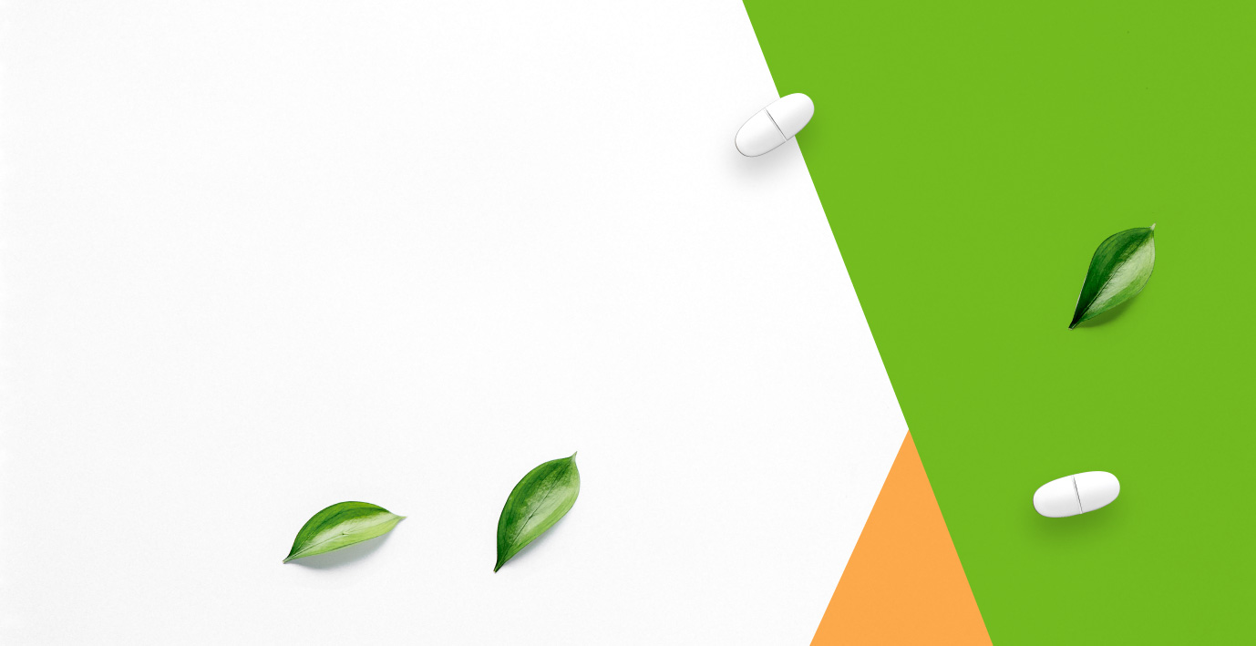 Orange and green vitamin tablet background