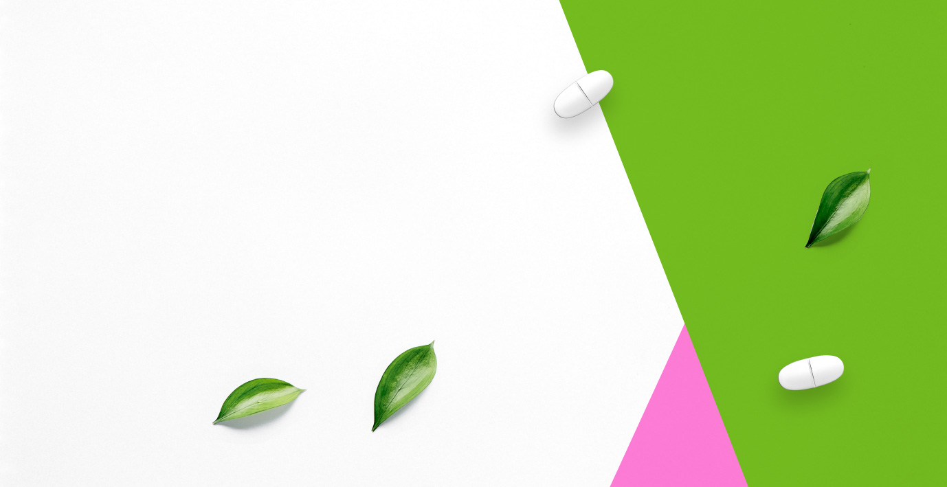 Pink and green background with vitamins