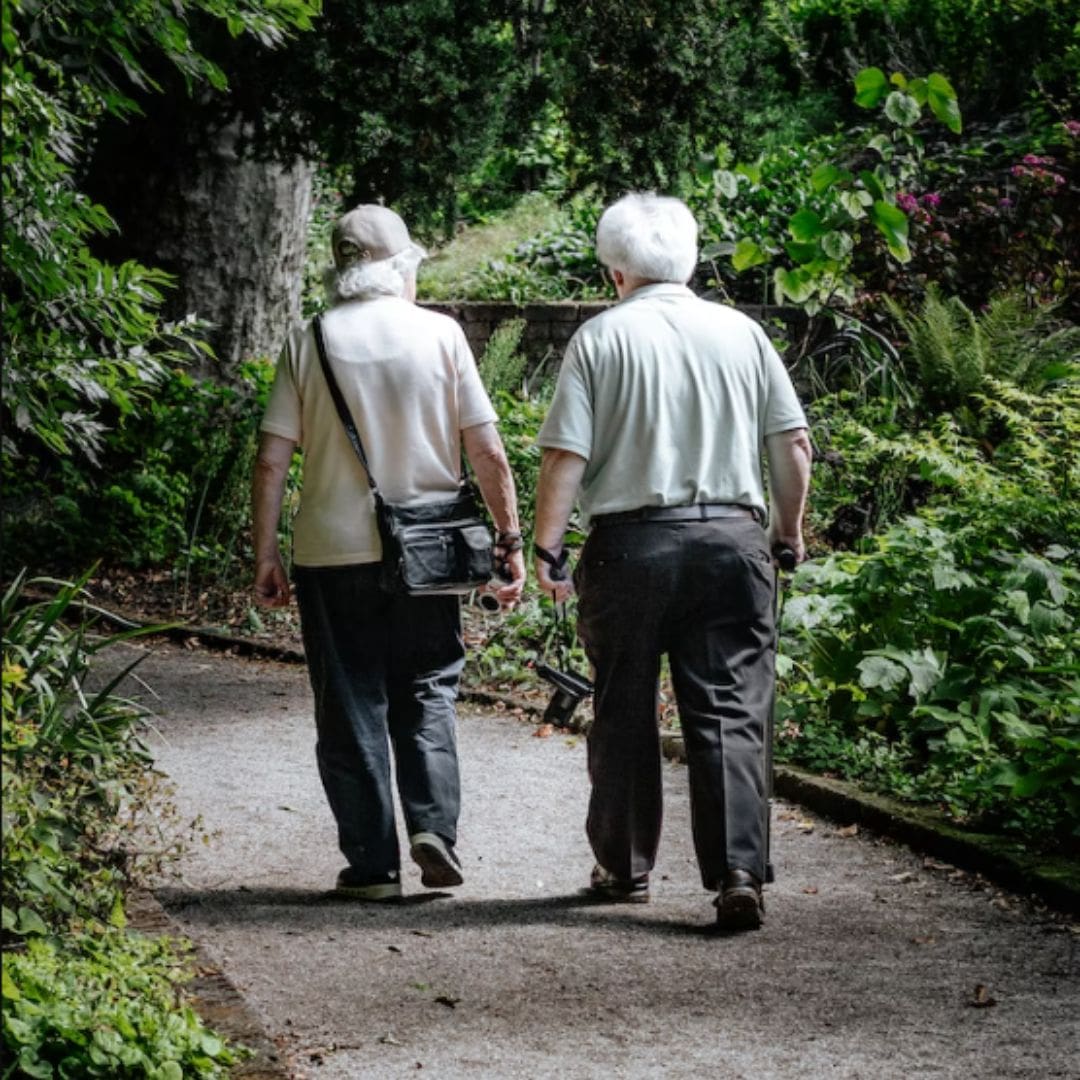 Elderly couple walking and holding hands